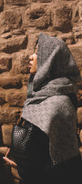 Person wearing a gray patterned shawl crafted in baby alpaca