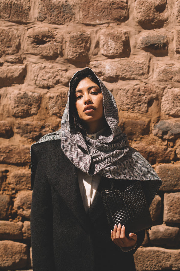 Woman wearing an elegant baby alpaca shawl and coat 
